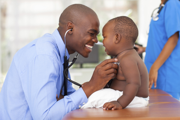 African doctor helping young african baby